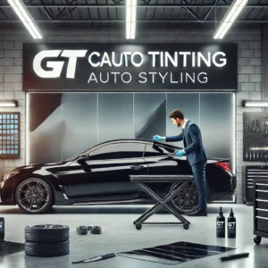 Skilled technician performing car window tinting in GT Auto Styling